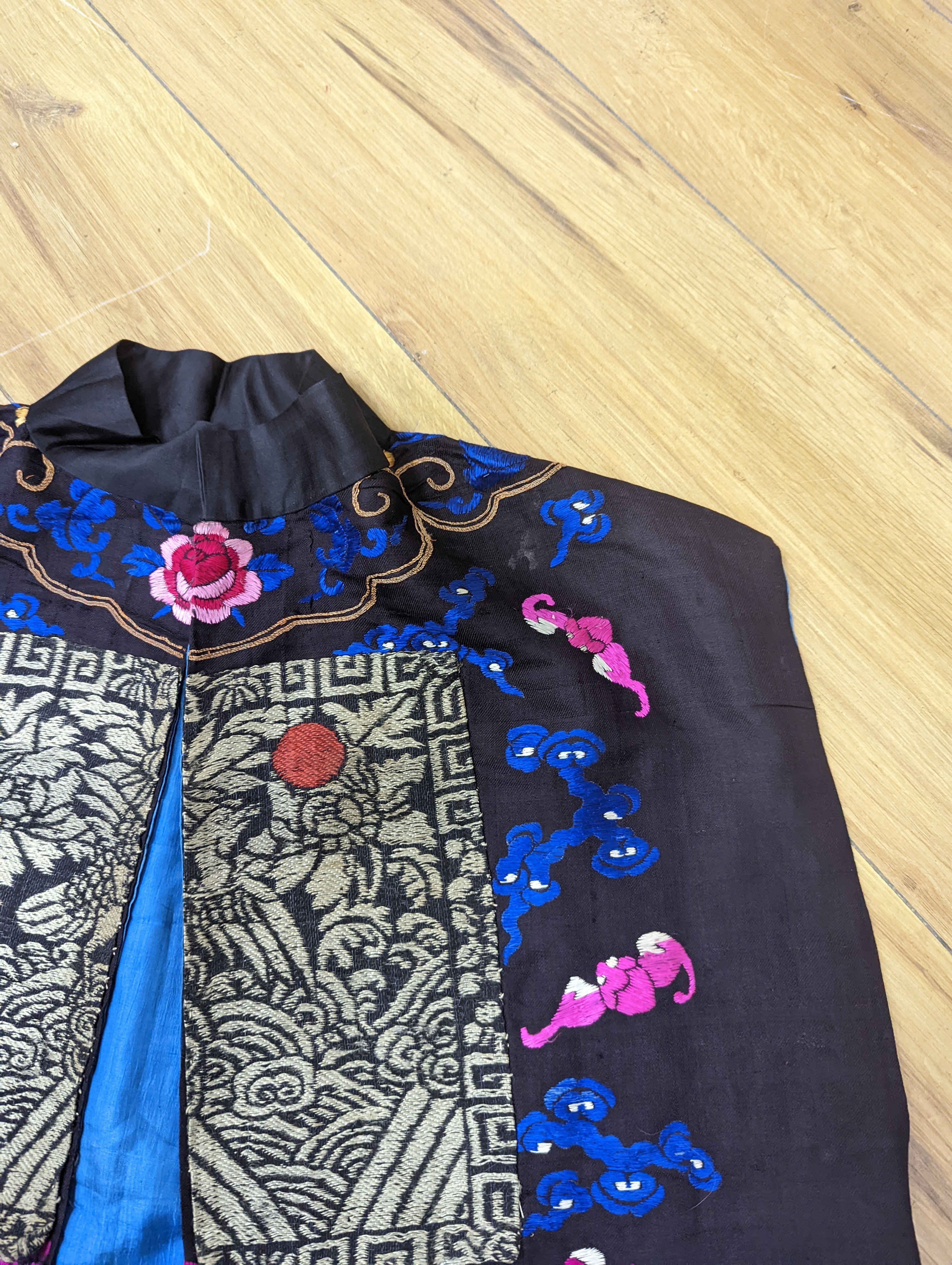 A 1920's Chinese dragon embroidered waistcoat, a cream silk drawn thread dress and a silk crepe black and patterned reversible kimono (3 items).
